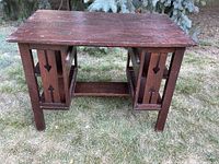 Front view of mission oak library table desk on grass