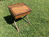 Full view of folding desk standing on lawn