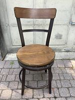 Front view of wooden seat and backrest on metal frame swivel chair