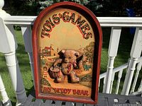 Full view of arched plaque on railing showing design and condition