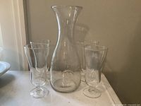 Carafe centered with four glasses around it