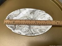 Top view showing full ashtray and ruler measuring about 11 in