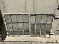 Both window sashes leaning against wall