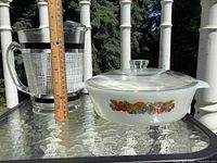 Pitcher and covered casserole side by side to show overall items and relative size