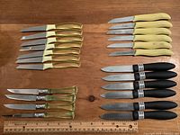 All four knife designs laid out with ruler for scale