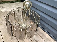 overall view of pendant chandelier showing cage frame and glass panels