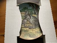 Plate inside cardboard insert showing kangaroo design
