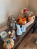 Overall view of assorted fall decor on console table