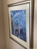 Angled view of entire framed print displaying image, matting and frame
