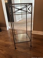 Full view showing metal frame and two glass shelves