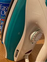 Close-up of Kenmore steam iron control dial and teal body