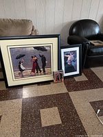 All four pieces of artwork and booklet leaning against wall