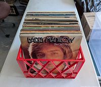 Front view of crate showing Barry Manilow album leading stack