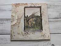 Front cover of textured sleeve showing man with sticks image