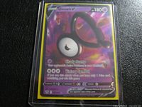 Front view of sleeved Unown V card