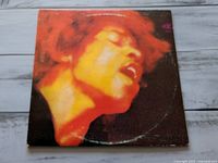 Front cover showing orange-tinted portrait of Jimi Hendrix