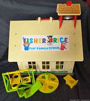 Front view of schoolhouse with bell tower and playground accessories