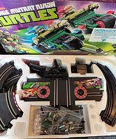 Interior tray with track, cars, controllers and accessories neatly packed