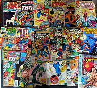 Group photo of all 23 comic books spread out showing covers