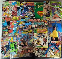 Single overview image showing 25 assorted comic books laid out in rows