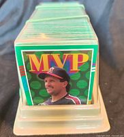 Stack of baseball cards in clear plastic holder, front card an MVP insert