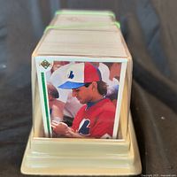 Front view of cards in beige plastic box, visible card shows Montreal Expos player