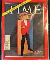Front cover of Time magazine showing date, headline banner, autograph, mailing label and protective sleeve
