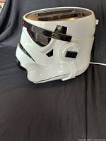 Left-front view of white Stormtrooper helmet toaster showing two slice slots, visor details and power cord