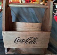 Front view of wooden Coca-Cola caddy showing logo and handle
