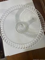 Top view of glass cake stand showing open-loop rim and pedestal center
