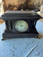 Front view showing dial, columns, metal feet