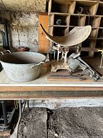 Overall lot showing scale with scoop pan, galvanized tub, grinder, rods
