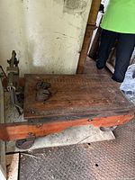 Full view of scale showing wooden platform, iron wheels and weights on deck