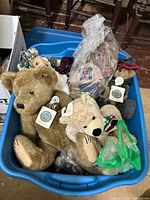 Overall view of blue tote containing multiple Boyds Bears jointed teddy bears, hang tags visible