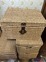 Closed wicker basket trunk showing latch and exterior weave