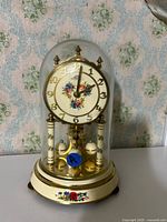 Front view showing clock under glass dome