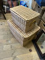 Both wicker baskets stacked, showing exterior weave and hinged lids