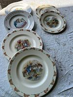 Six children’s porcelain plates and bowls arranged to show all designs