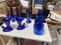 Group shot of entire lot on white table showing all cobalt blue pieces