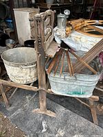 Full view of metal folding frame with wringer and nearby slats