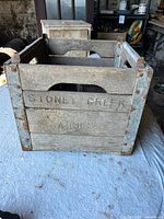 Front view showing faded "STONEY CREEK DAIRIES" lettering and corner braces