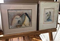 Both framed prints on easel