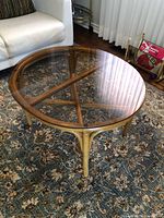 Three-quarter view showing bamboo frame, glass top and overall wear