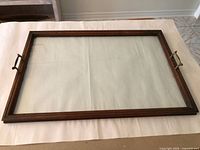 Full view of rectangular tray showing glass insert, wood frame, both handles