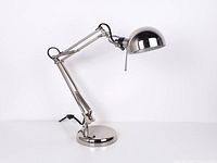 Full view of chrome articulating desk lamp at maximum height