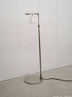 Full view of adjustable metal floor lamp unlit
