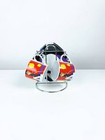 Front view of two espresso cups hanging on stand with saucers behind