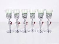 Front view of six shot glasses in metal knight holders