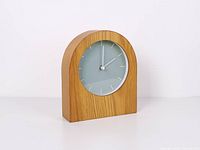 Front angled view showing oak body and clock face