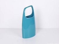 Front view of teal stoneware vase showing handle cut-out and glossy finish